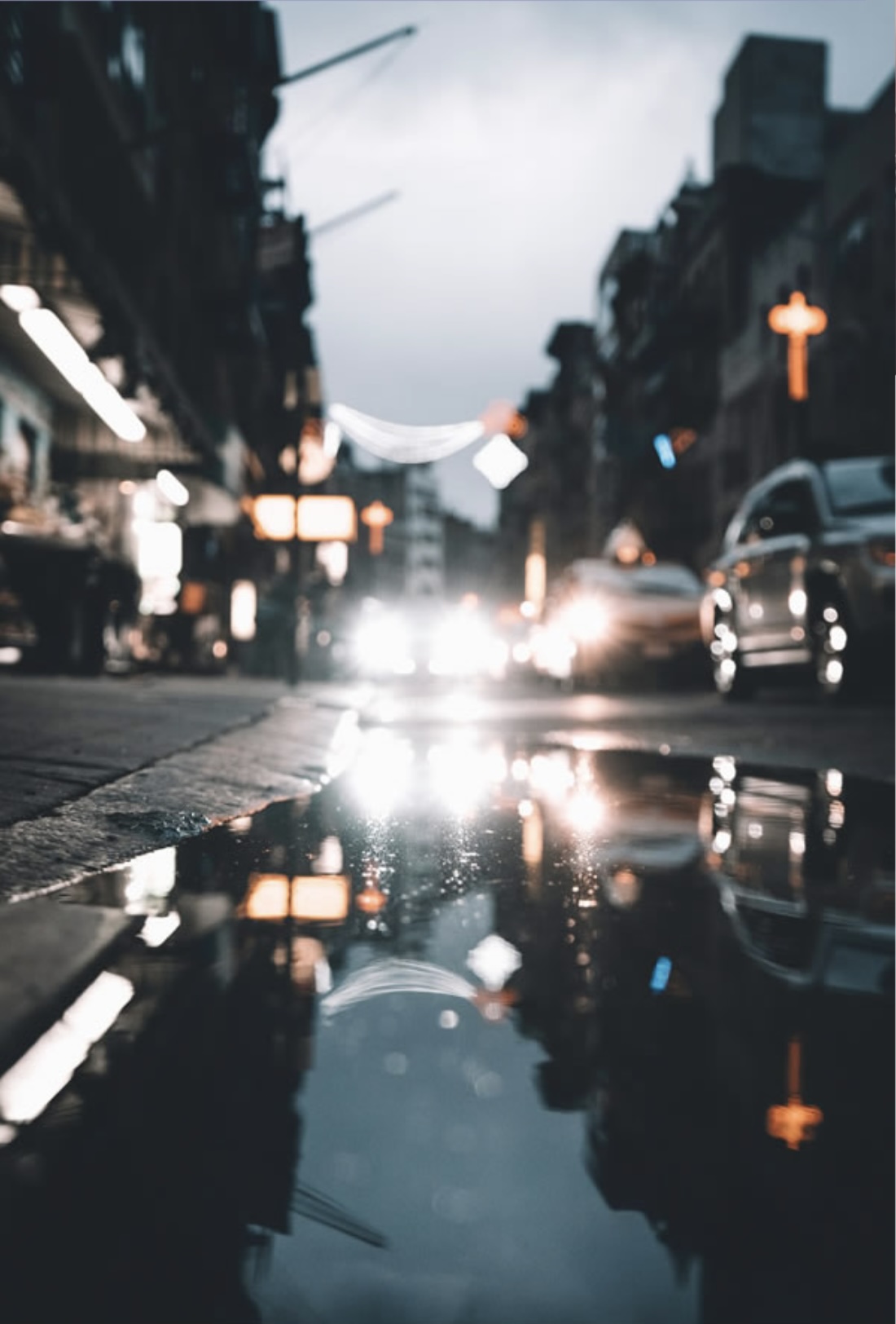 Decorative image. Wet street at night showing reflections of car lights.